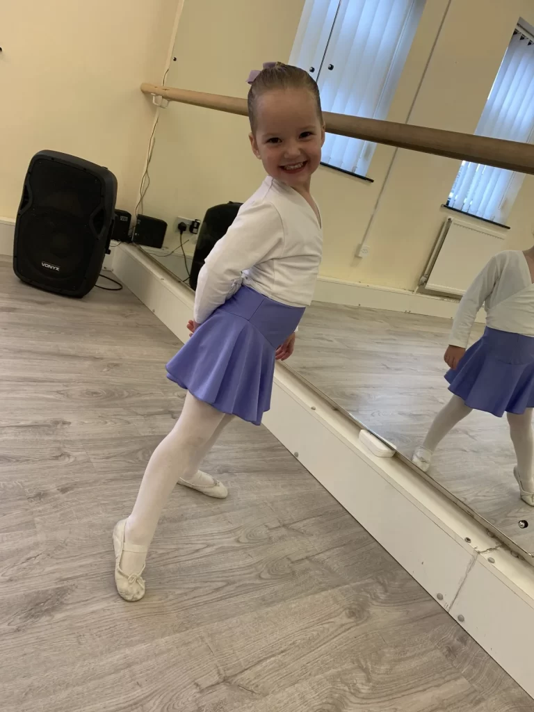 A young pupil in ballet kit at the barre in the Slater Stars studio